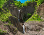 beautiful-waterfall-in-the-mountains_361360-8776